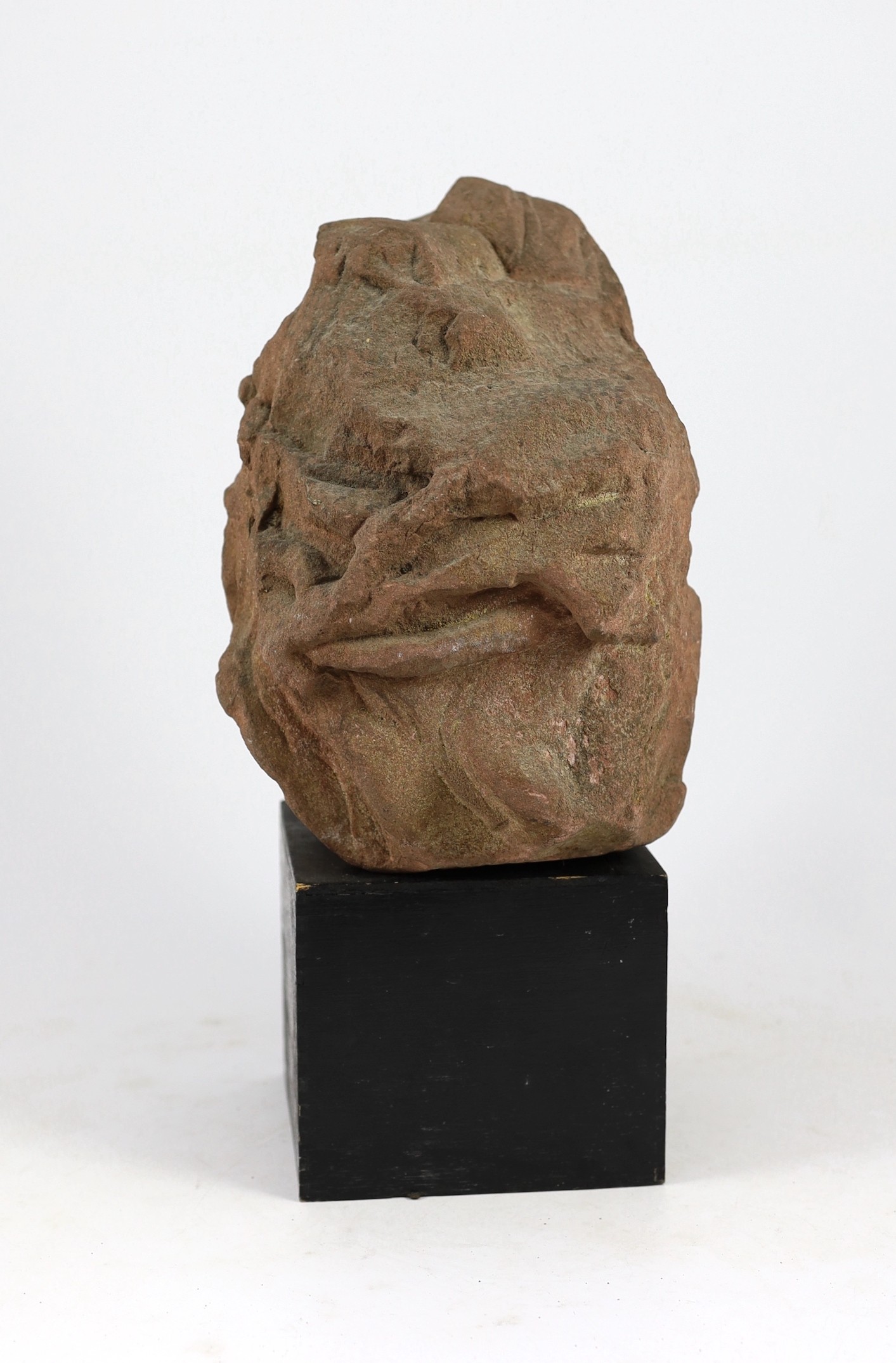 A weathered sandstone head of Christ, probably 12th century, 26cm high